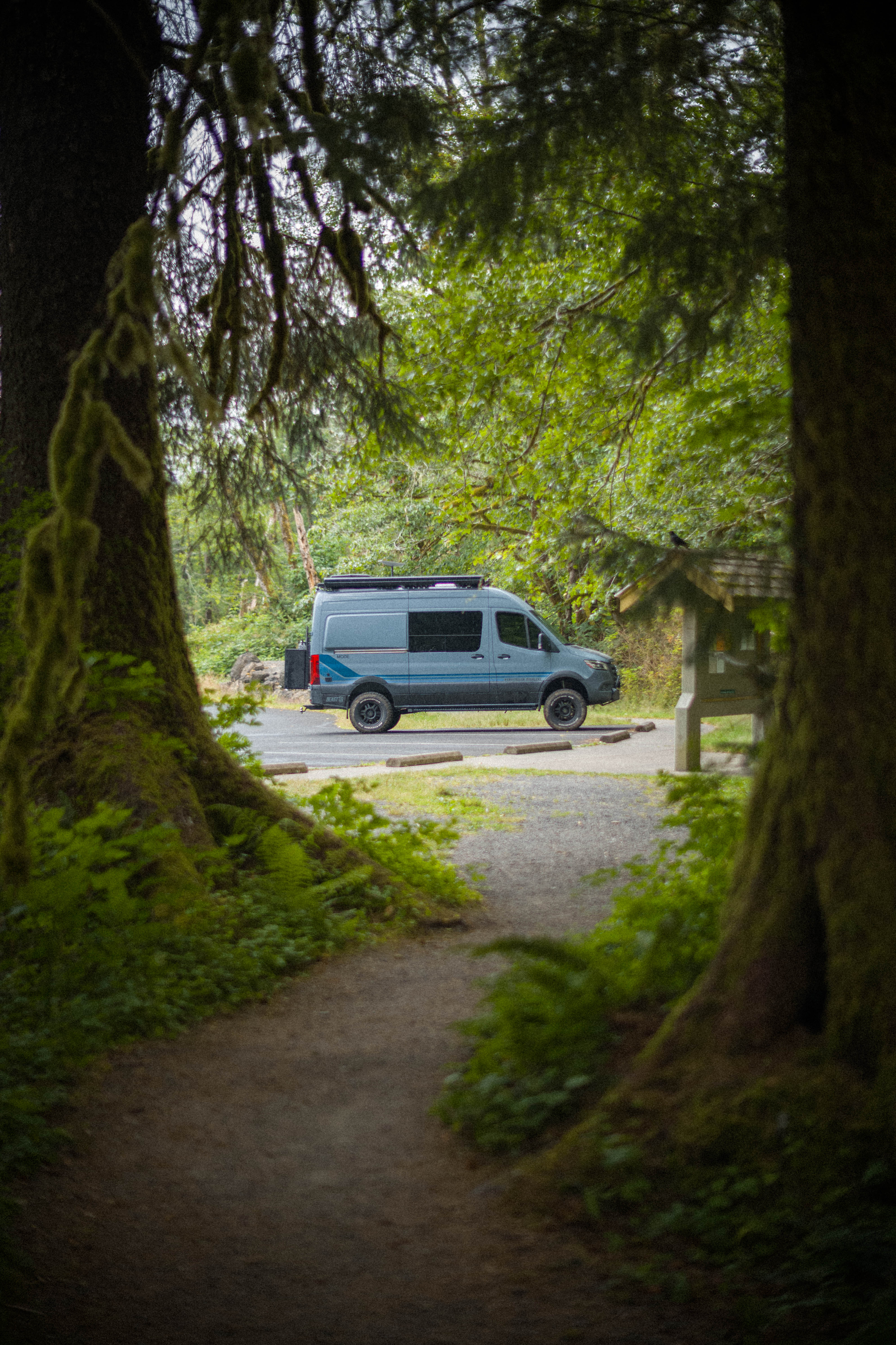 My van parked at a trailhead in the Pacific Northwest, back on the road